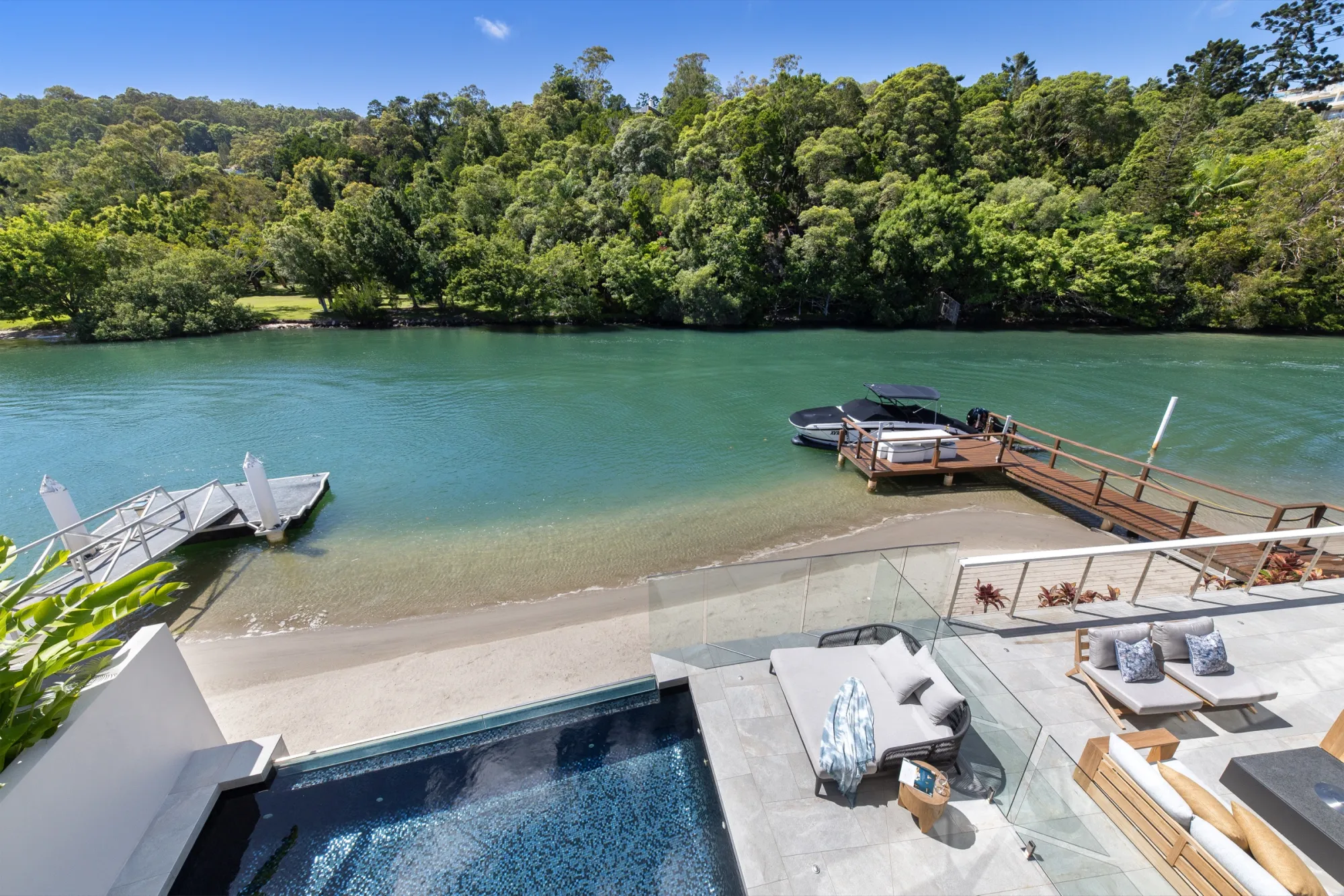 Heated infinity pool overlooking the Noosa River at sunset